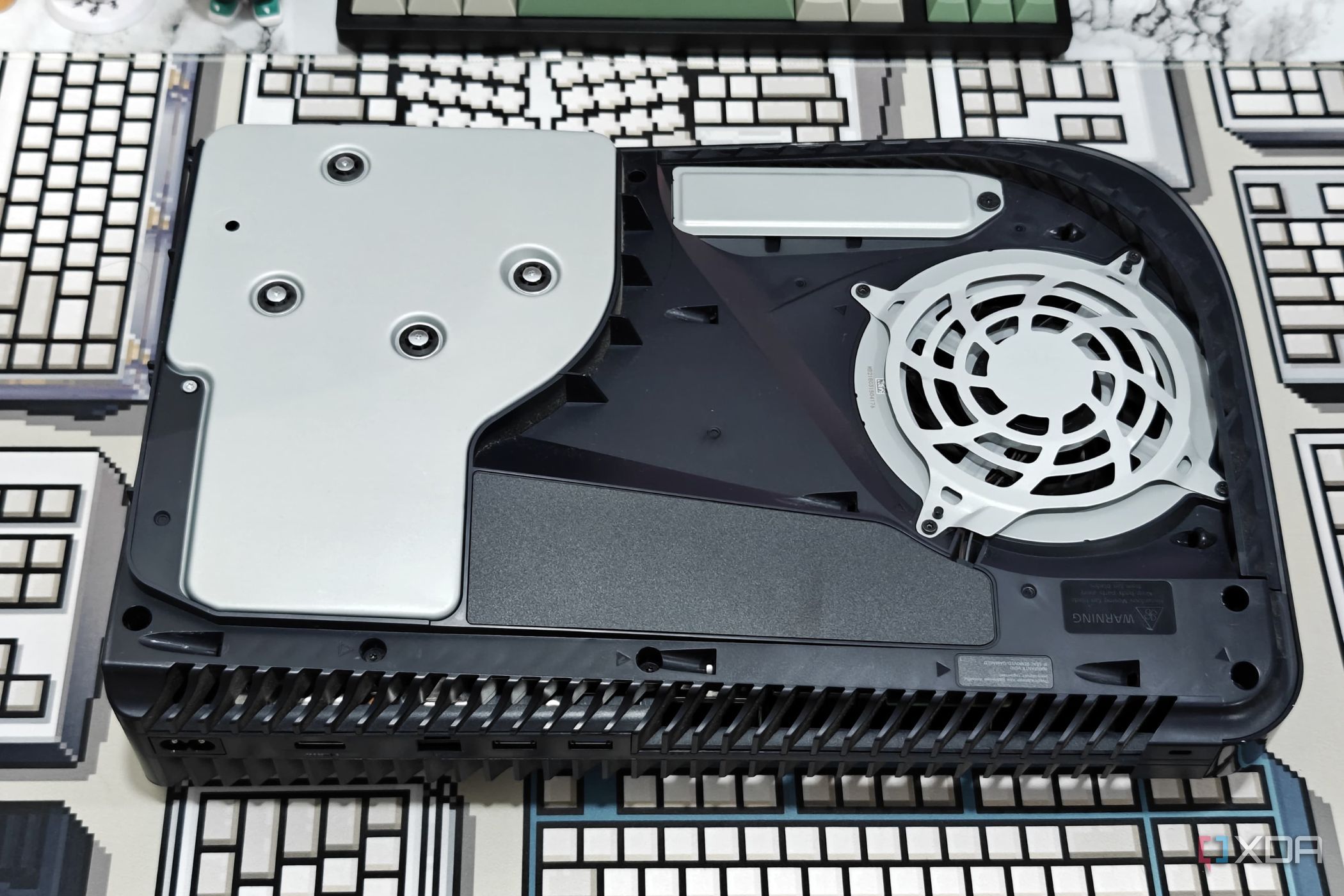 An image showing a PS5 laying flat on a table without the side panel.