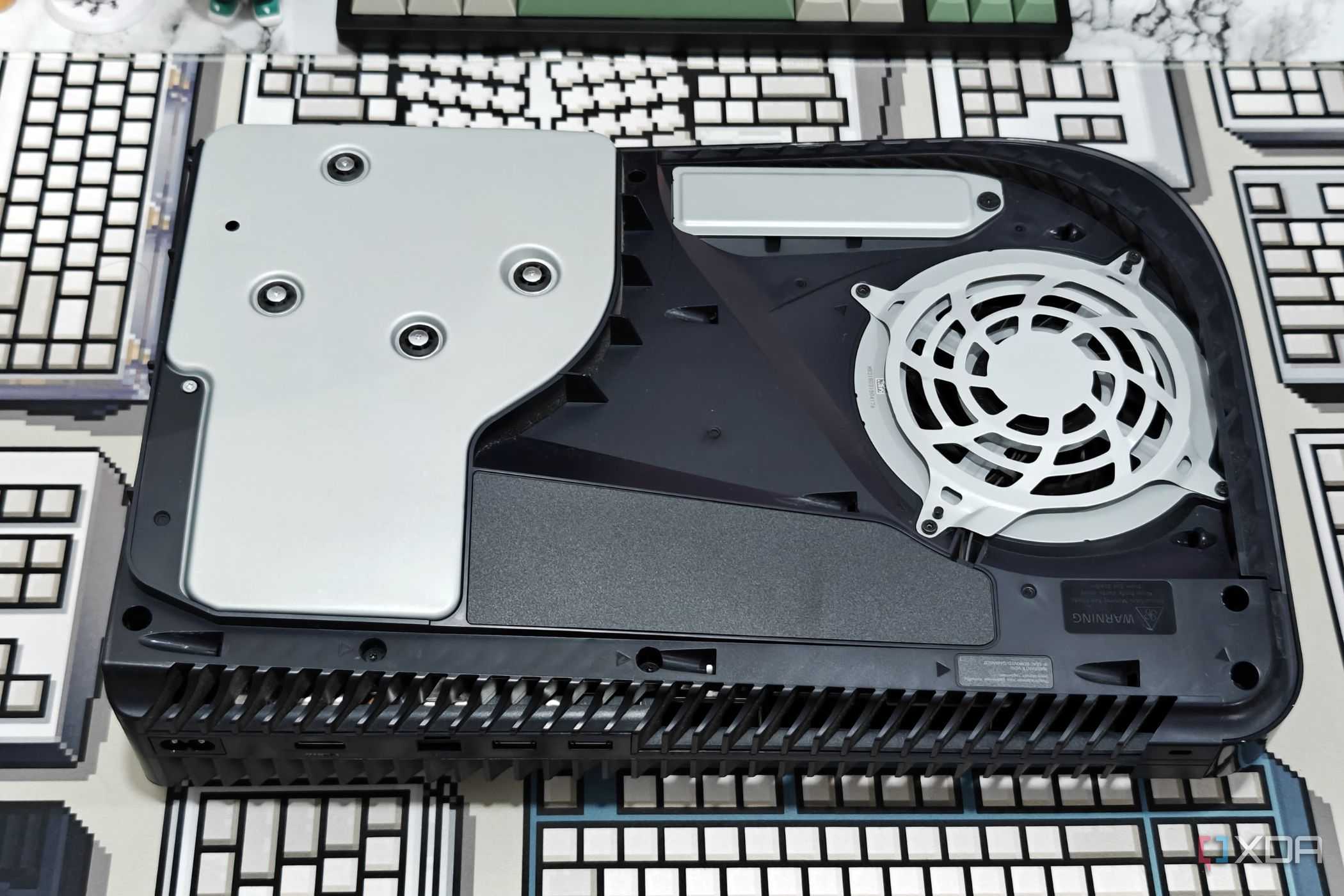 An image showing a PS5 laying flat on a table without the side panel.