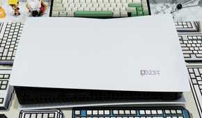 An image showing a PS5 laying flat on a table with a CRP deskmat.