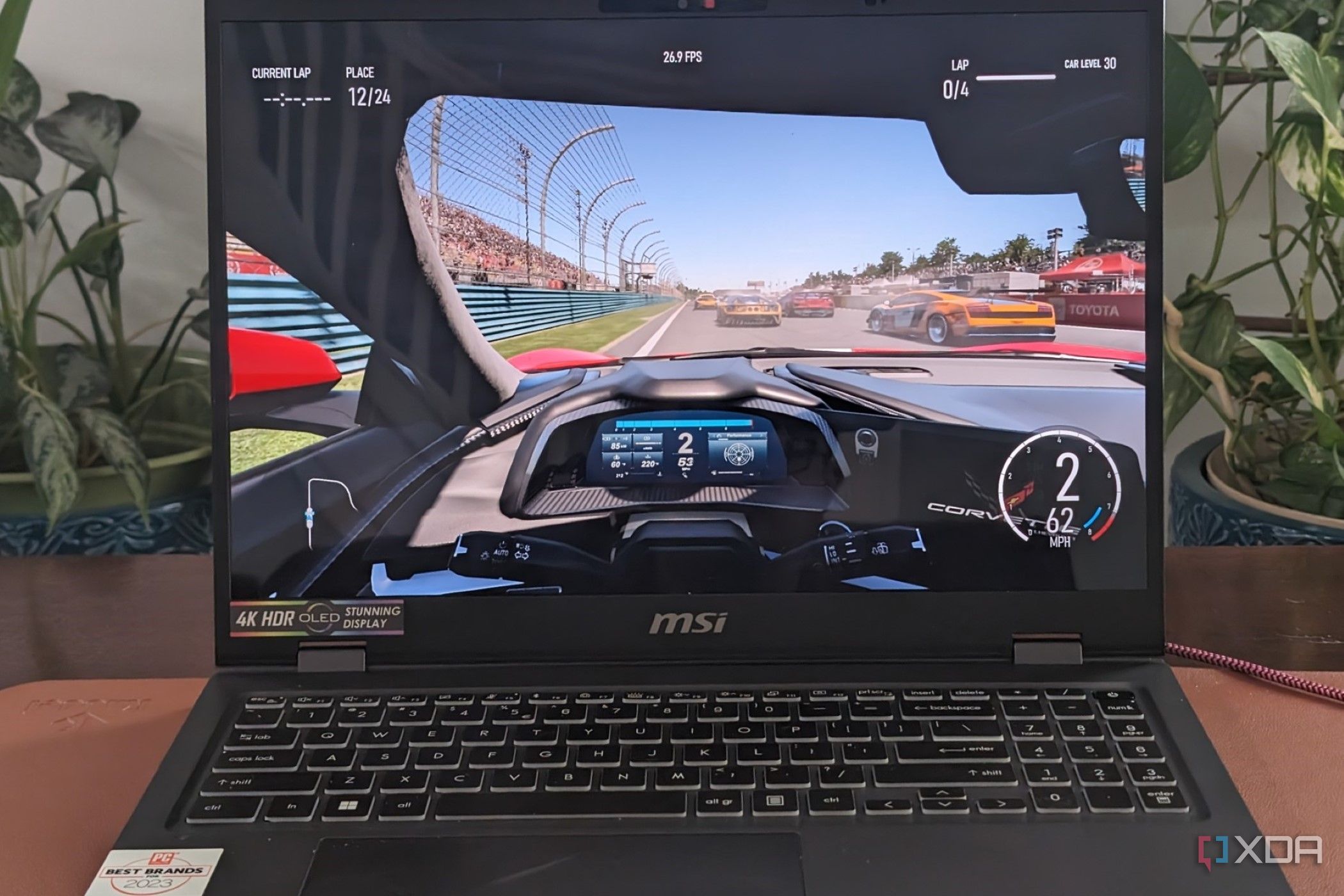A photo of playing Forza Motorsport on the MSI Prestige 16 AI Evo laptop showing framerates at the top of the screen