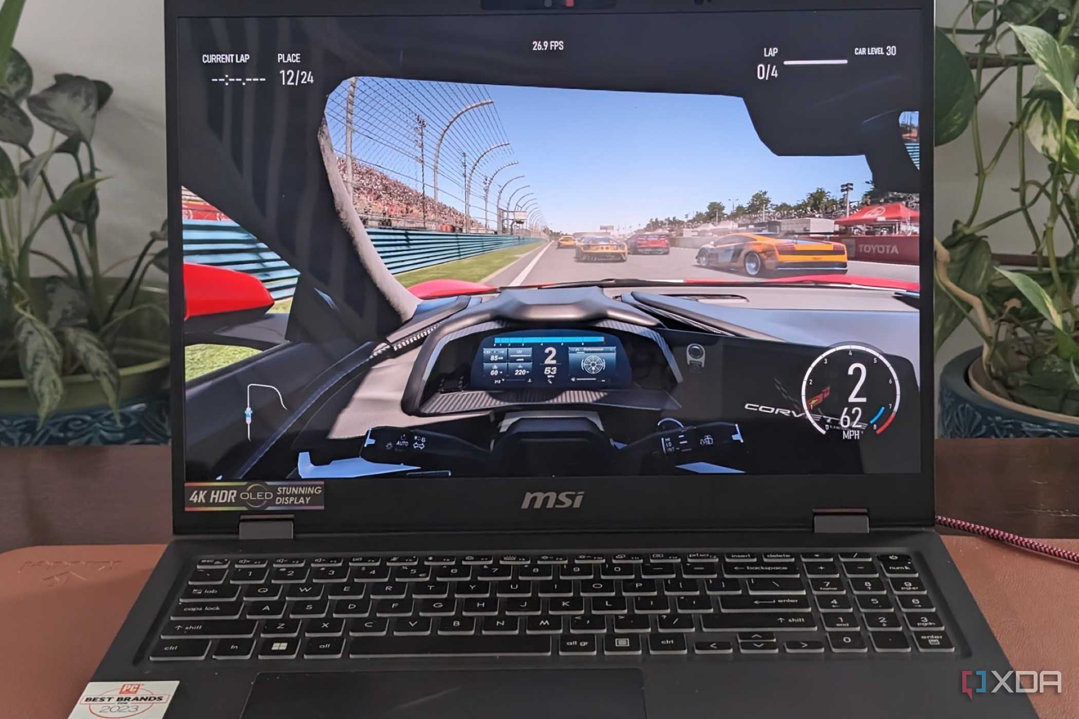 A photo of playing Forza Motorsport on the MSI Prestige 16 AI Evo laptop showing framerates at the top of the screen