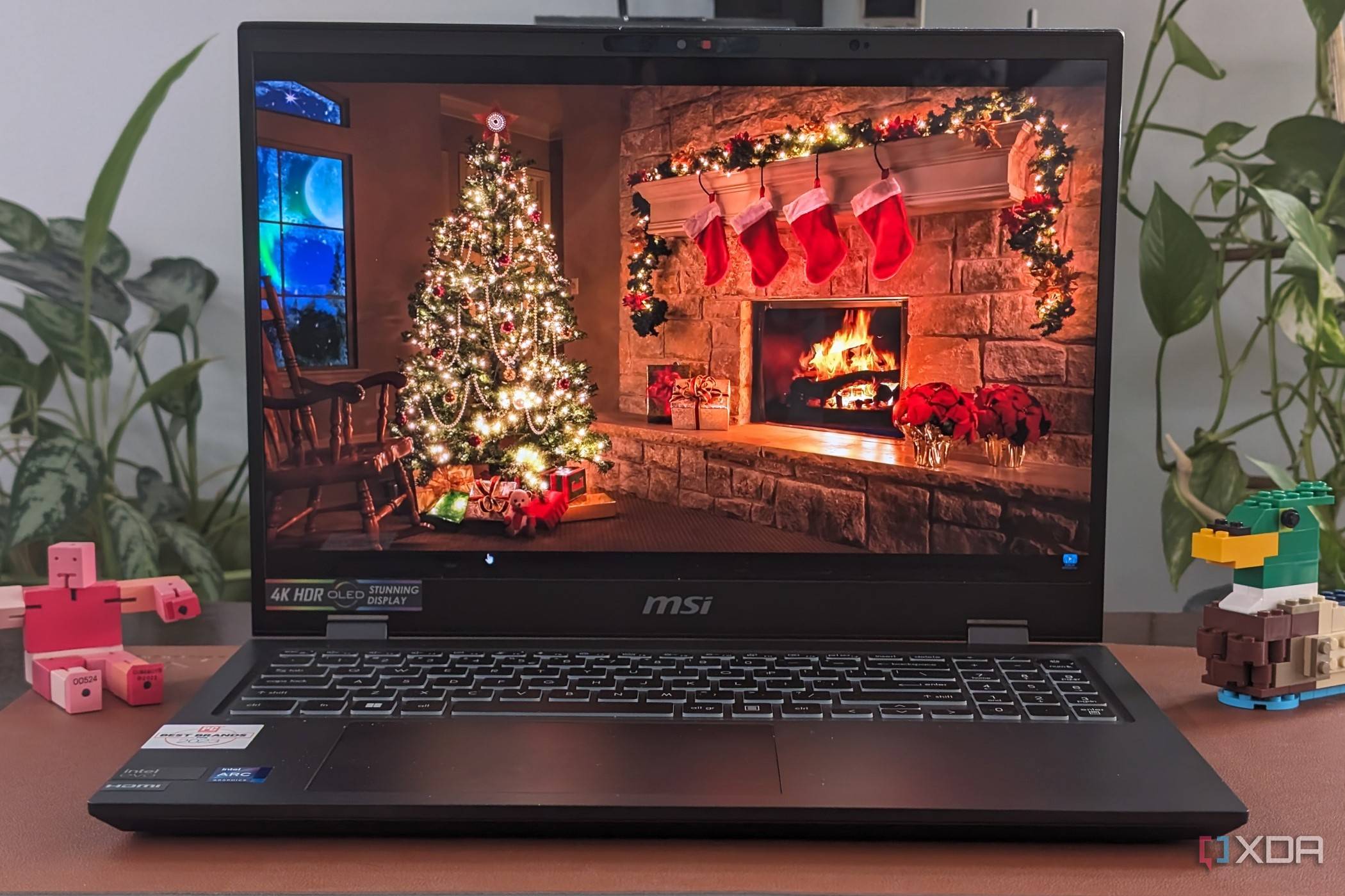 A photo of the display on the MSI Prestige 16 AI Evo showing a chrismtad scene with fireplace