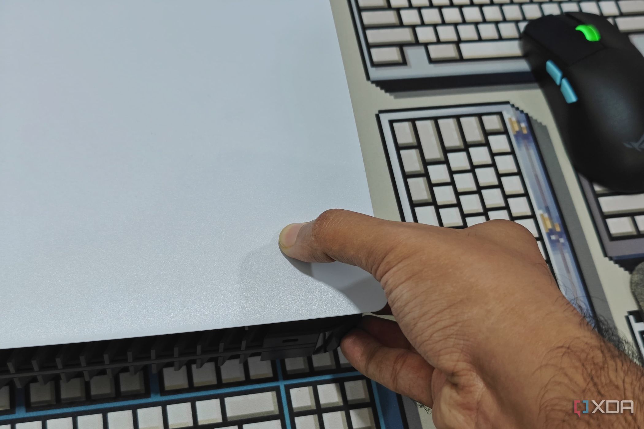 An image showing a person trying to remove PS5 side panel.