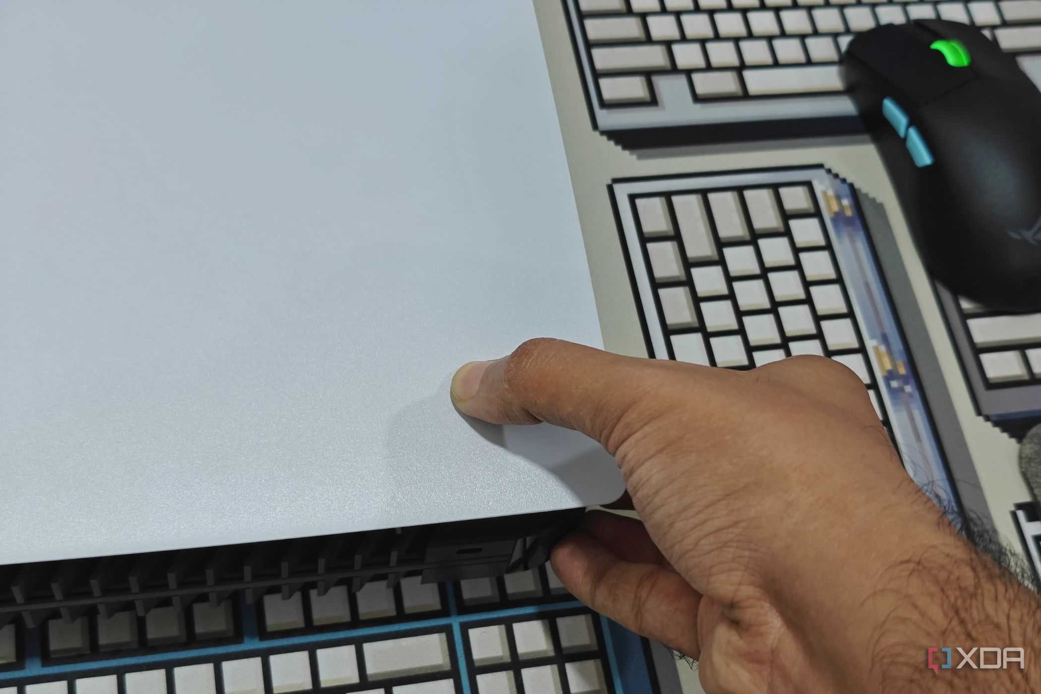 An image showing a person trying to remove PS5 side panel.