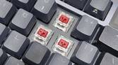 An image showing ASUS NX Red linear switches installed on an ROG Azoth keyboard.