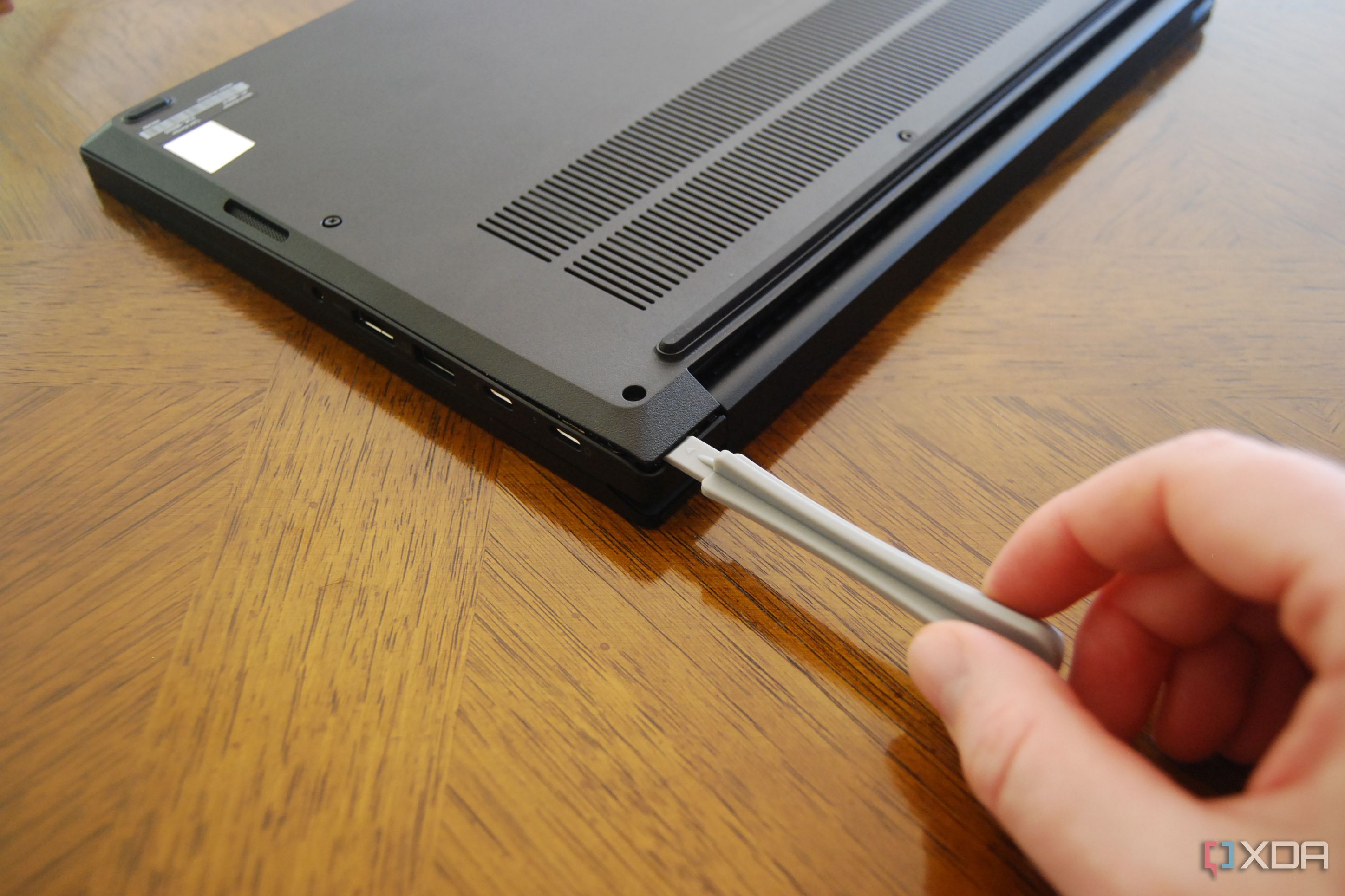Pry up the bottom panel using a plastic pry tool