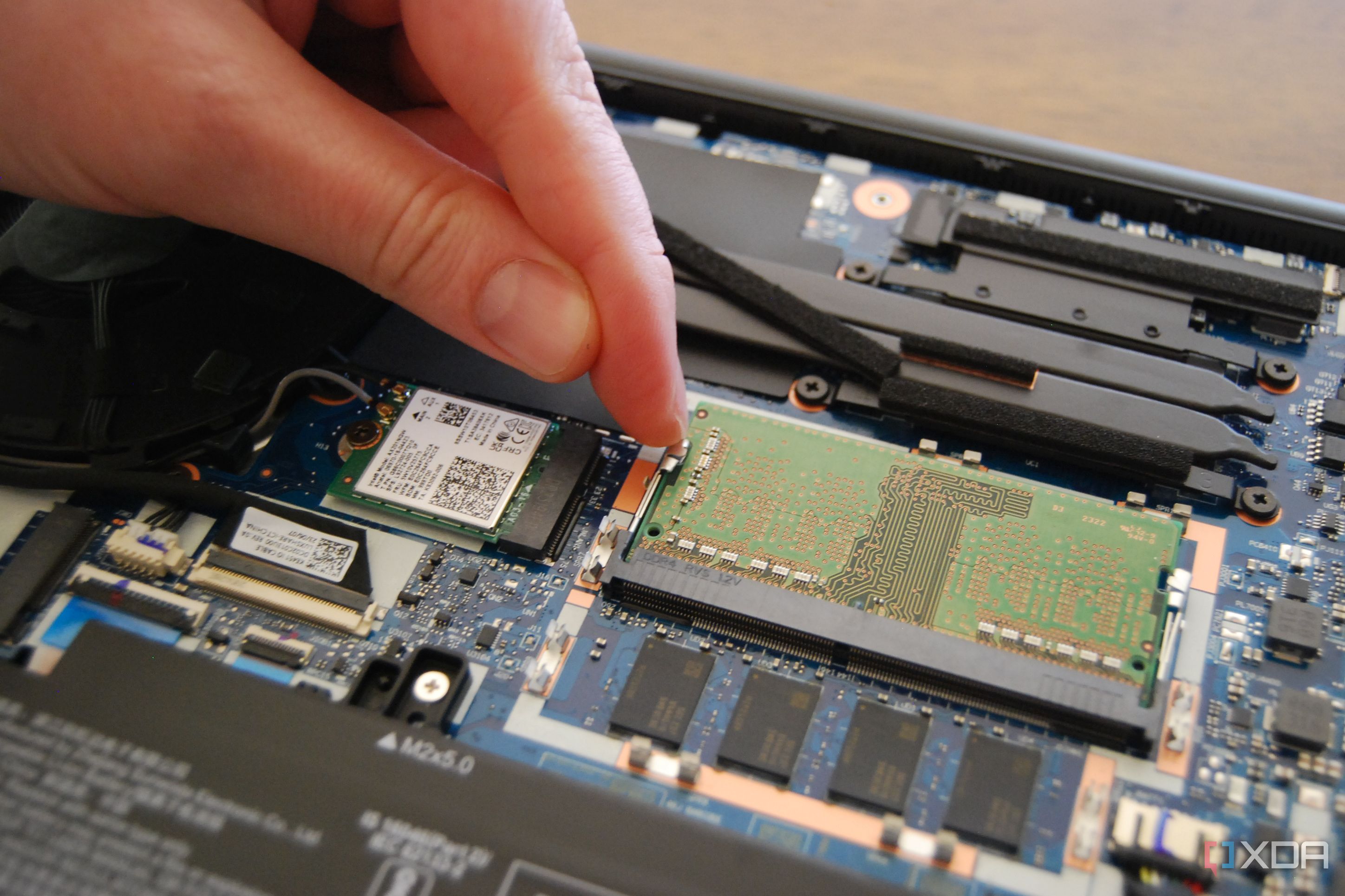 Pull the metal arms away from the RAM module
