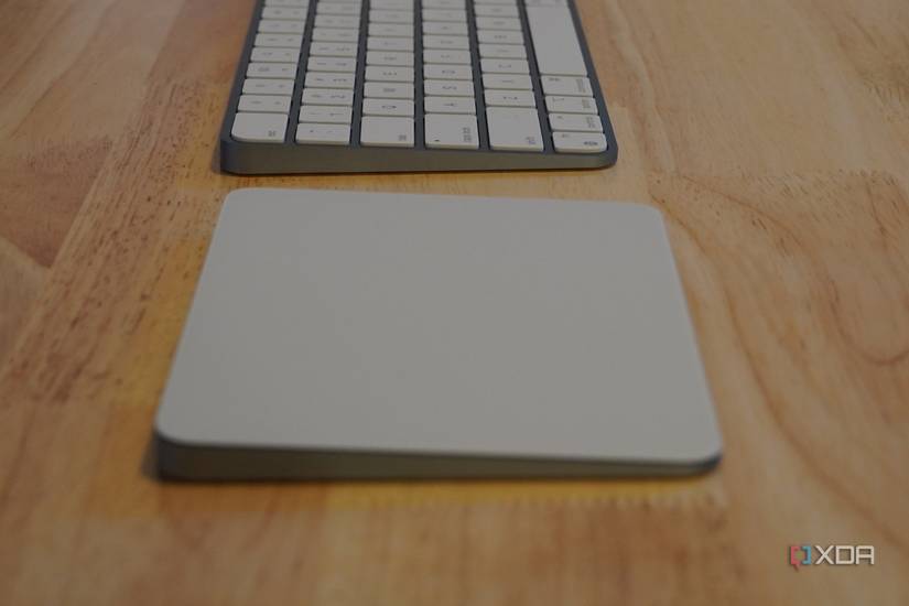 The side of a trackpad and keyboard on a desk.
