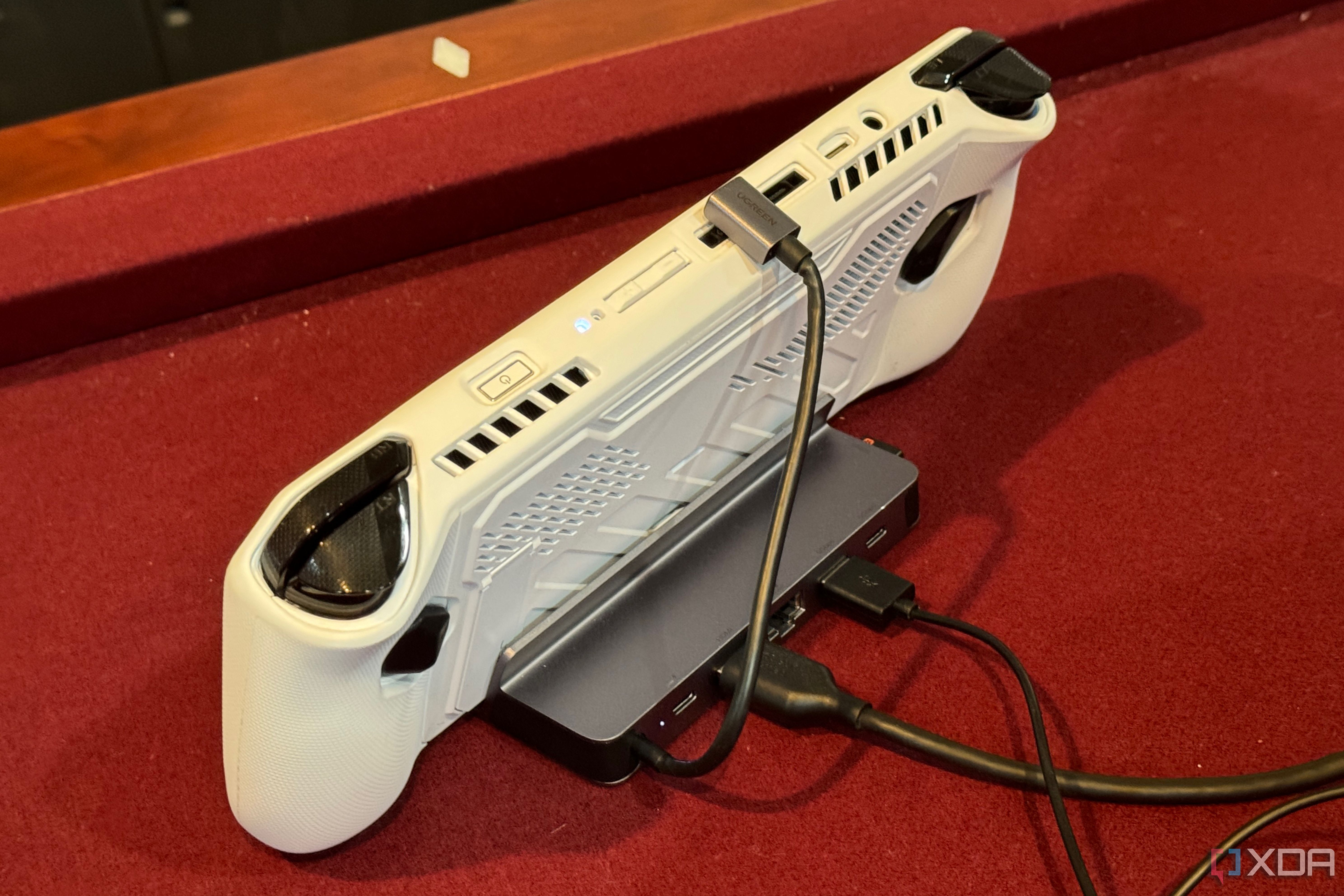 Cables coming out of the back of a UGreen dock for gaming handhelds.