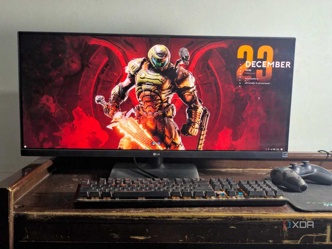 ultrawide monitor setup with doom eternal wallpaper