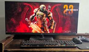 ultrawide monitor setup with doom eternal wallpaper