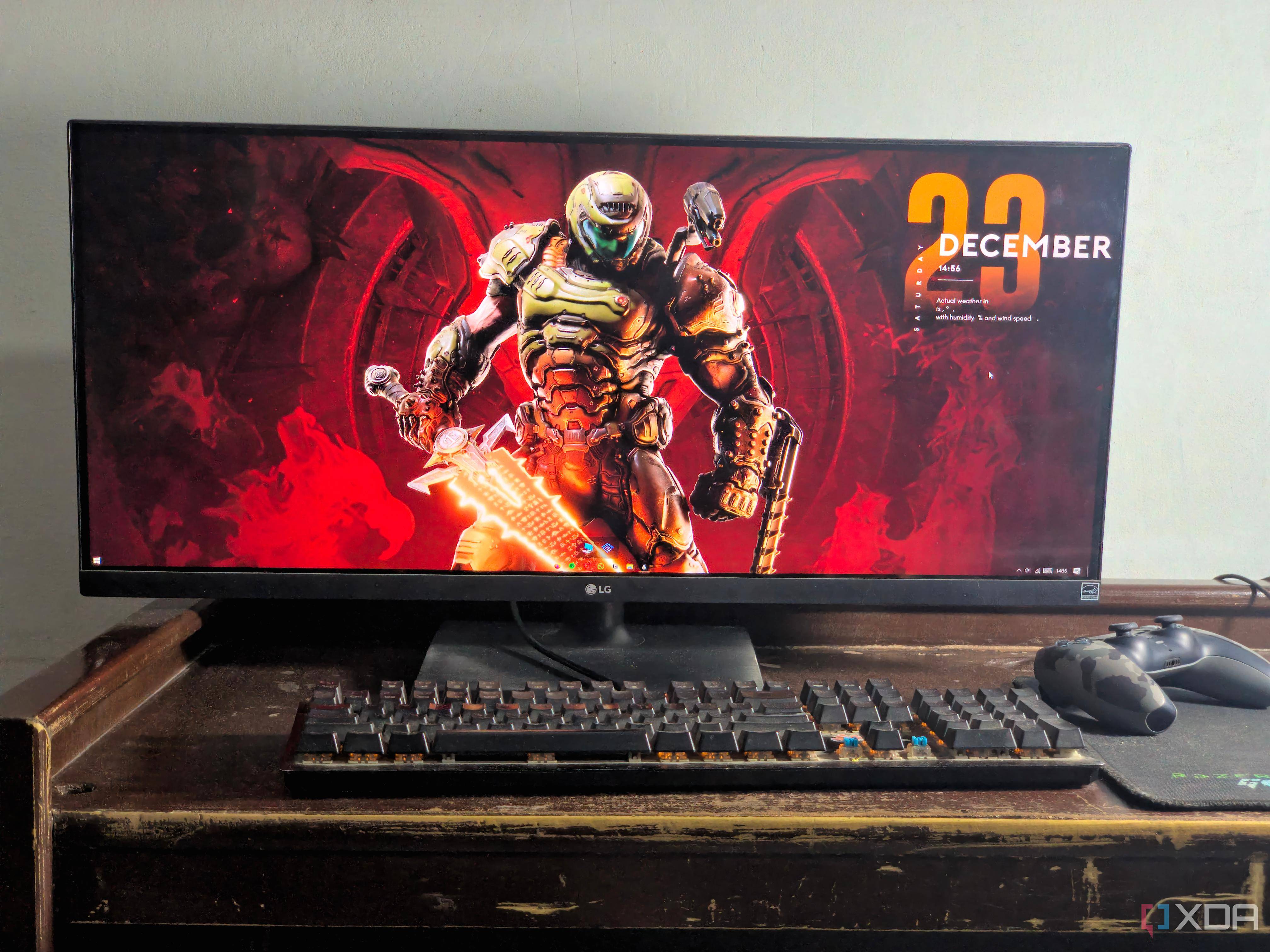 ultrawide monitor setup with doom eternal wallpaper