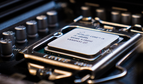 A close-up image of a CPU core i5, docked on a motherboard with the background blurred