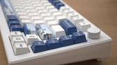 A close up image of the Akko Santorini focusing on the arrow keys and artwork keycaps