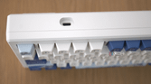 A top view of the Akko Santorini, displaying the USB-C charging port, with the keyboard keys blurred out