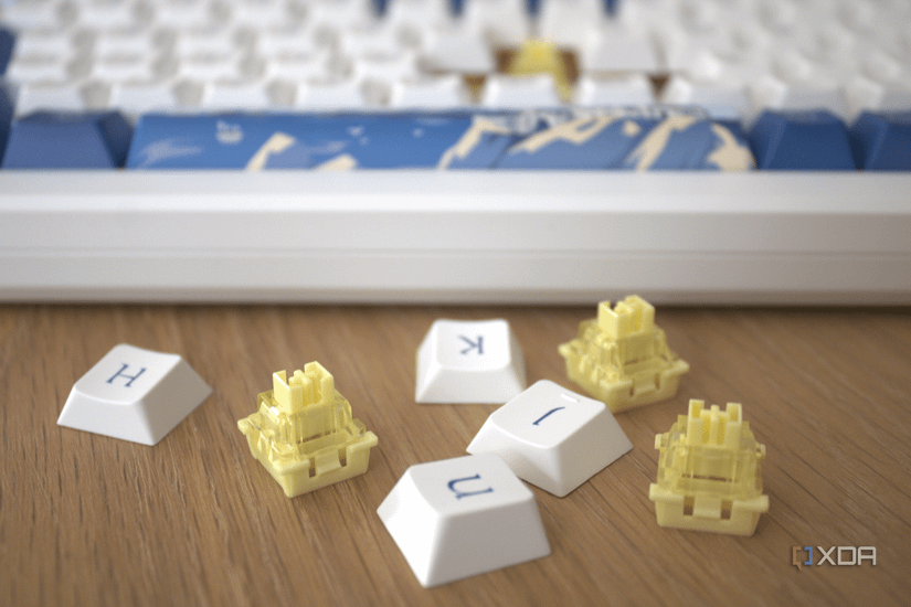 The Akko Santorini keyboard in the background with the keyboards switches and key caps in focus