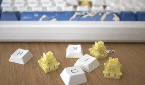 The Akko Santorini keyboard in the background with the keyboards switches and key caps in focus