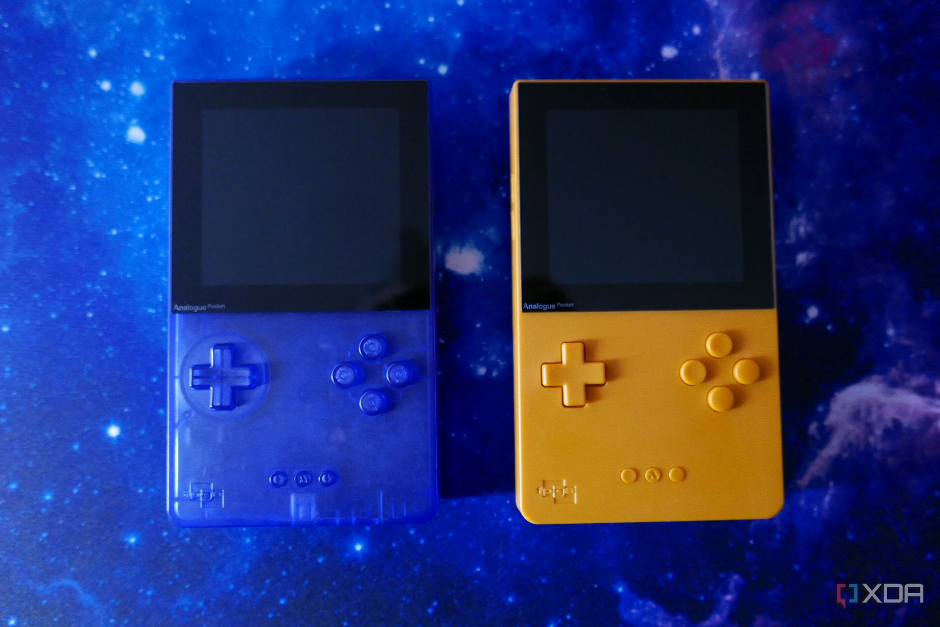A transparent blue Analogue Pocket and a yellow one side by side