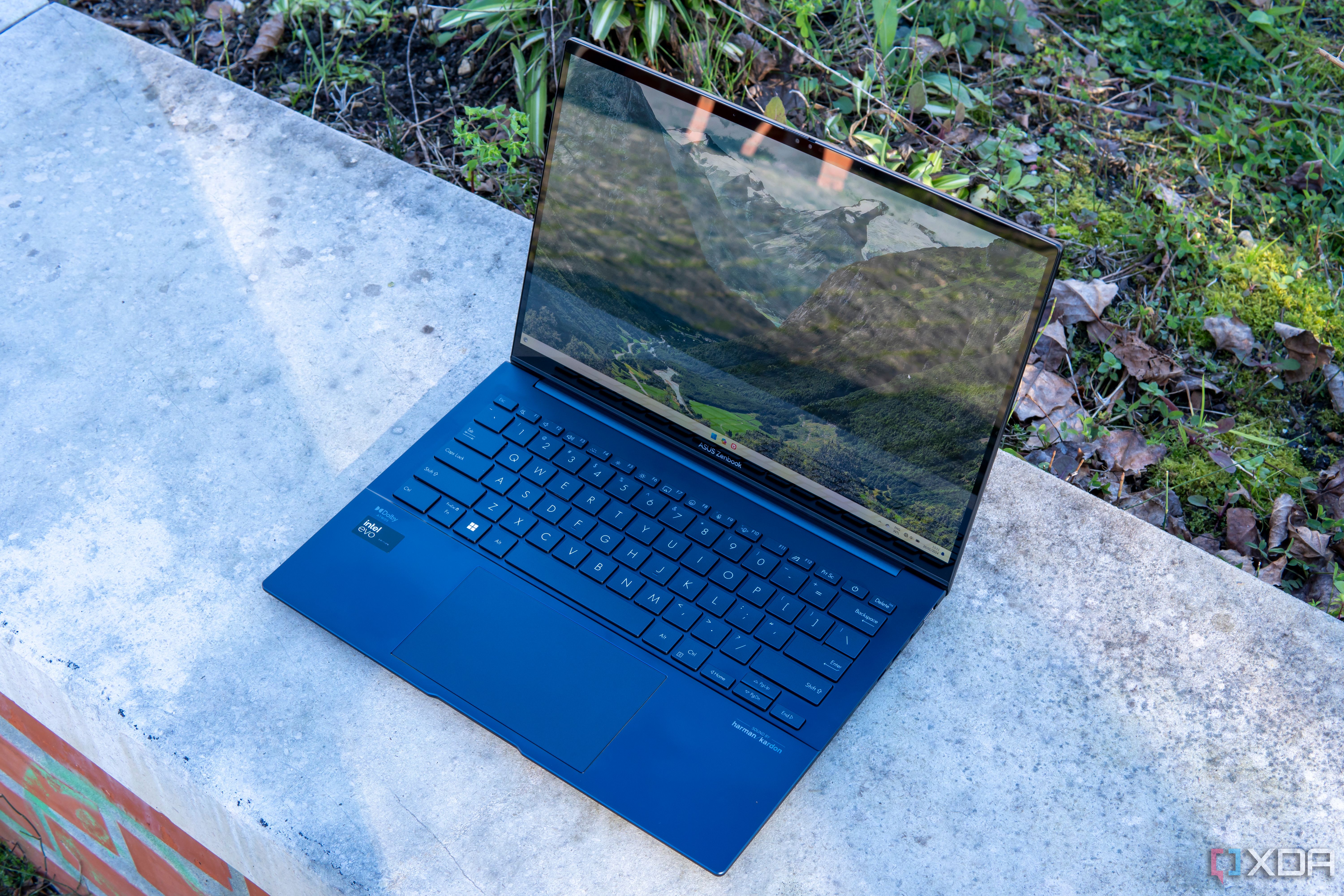 Angled front view of the Asus Zenbook 14 OLED with the lid open at about 100 degrees
