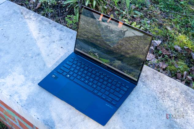 Angled front view of the Asus Zenbook 14 OLED with the lid open at about 100 degrees
