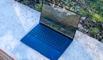 Angled front view of the Asus Zenbook 14 OLED with the lid open at about 100 degrees