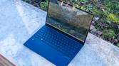 Angled front view of the Asus Zenbook 14 OLED with the lid open at about 100 degrees
