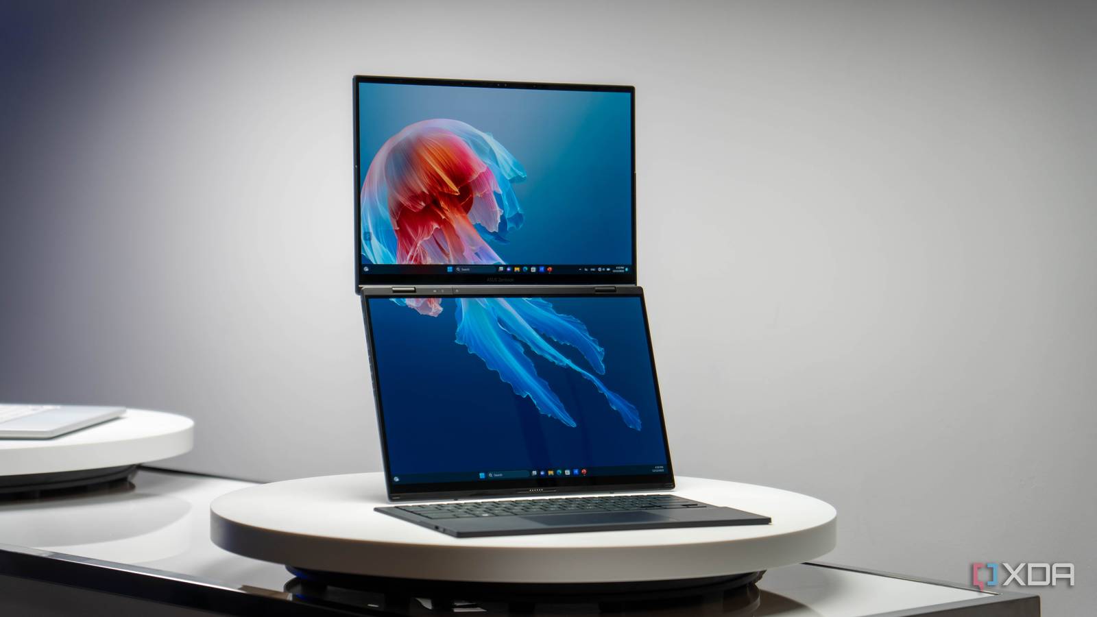Asus Zenbook Duo with two screens stacked vertically and a wireless keyboard in front of it