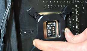 An image showing a person holding the backplate of a CPU cooler on the motherboard for installation.