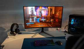 Dell QD-OLED monitor on a desk next to PC hardware