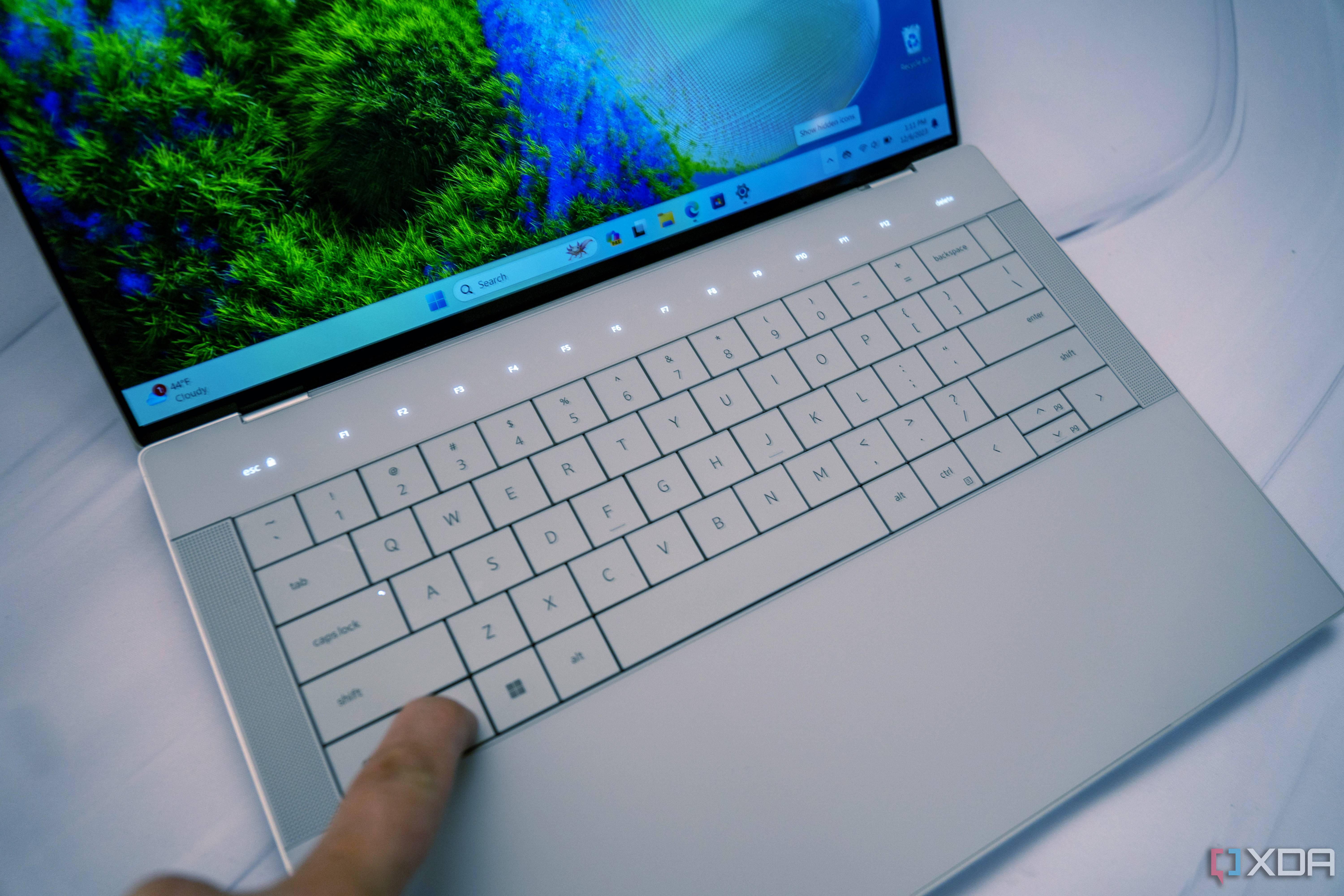 Angled view of the keyboard on the Dell XPS 14 with the touch function row illuminated