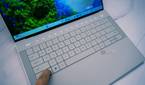 Angled view of the keyboard on the Dell XPS 14 with the touch function row illuminated