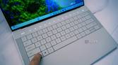 Angled view of the keyboard on the Dell XPS 14 with the touch function row illuminated