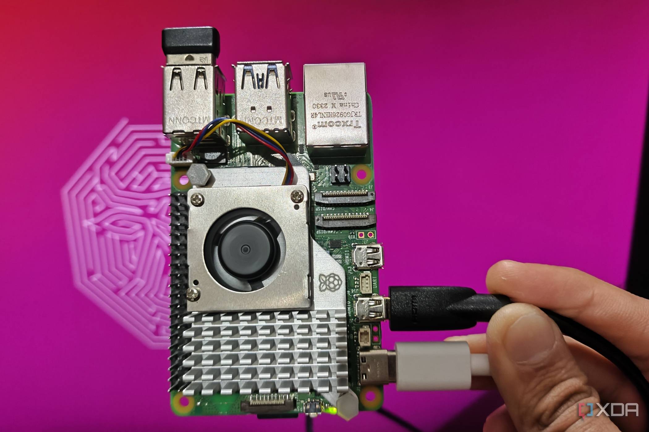 An image of a Raspberry Pi 5 kept in front of a monitor displaying the default Ubuntu GNOME desktop