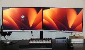 The front of a desk setup using the Insignia dual monitor mount.