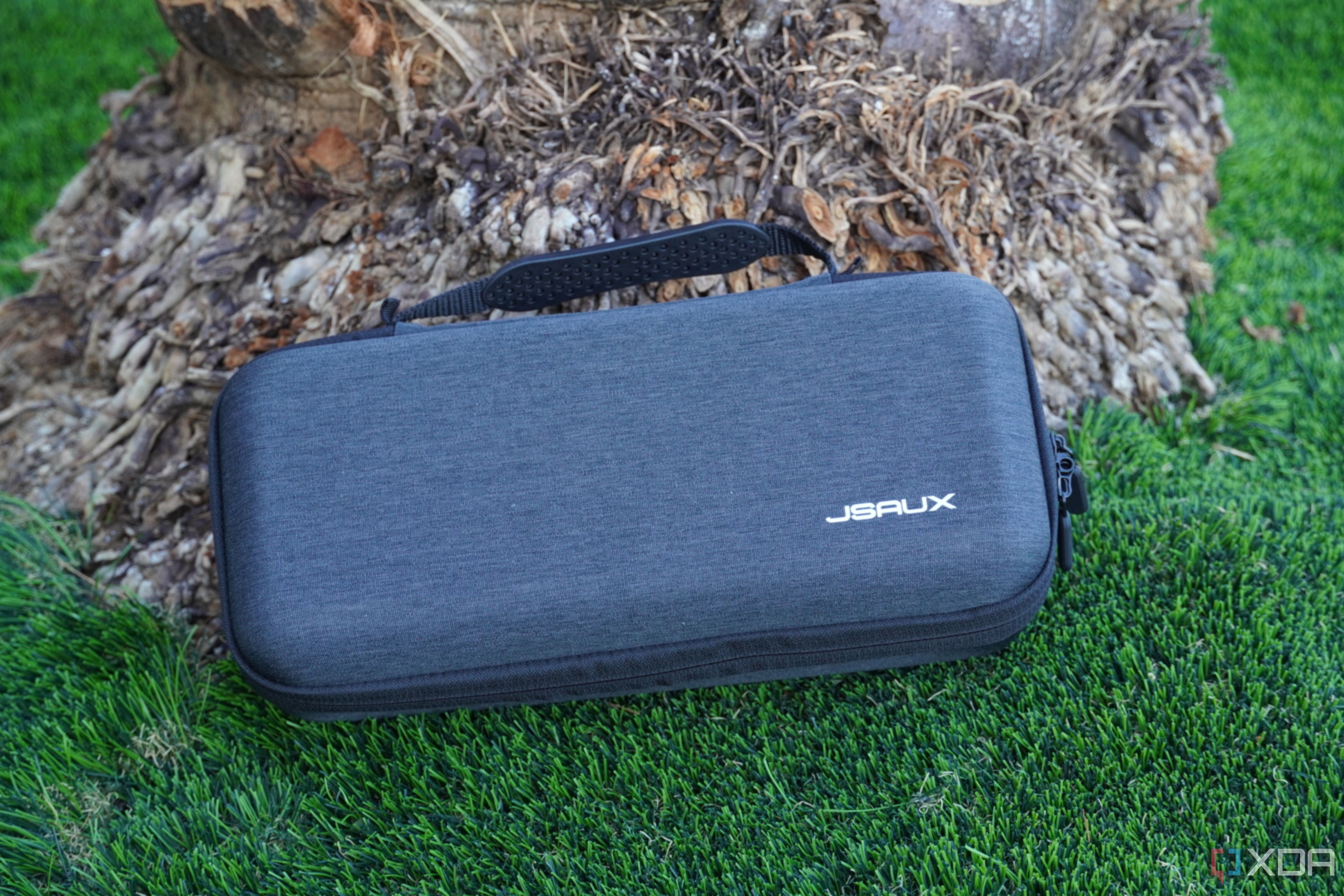 The Jsaux Carrying Case resting against a palm tree.
