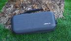 The Jsaux Carrying Case resting against a palm tree.