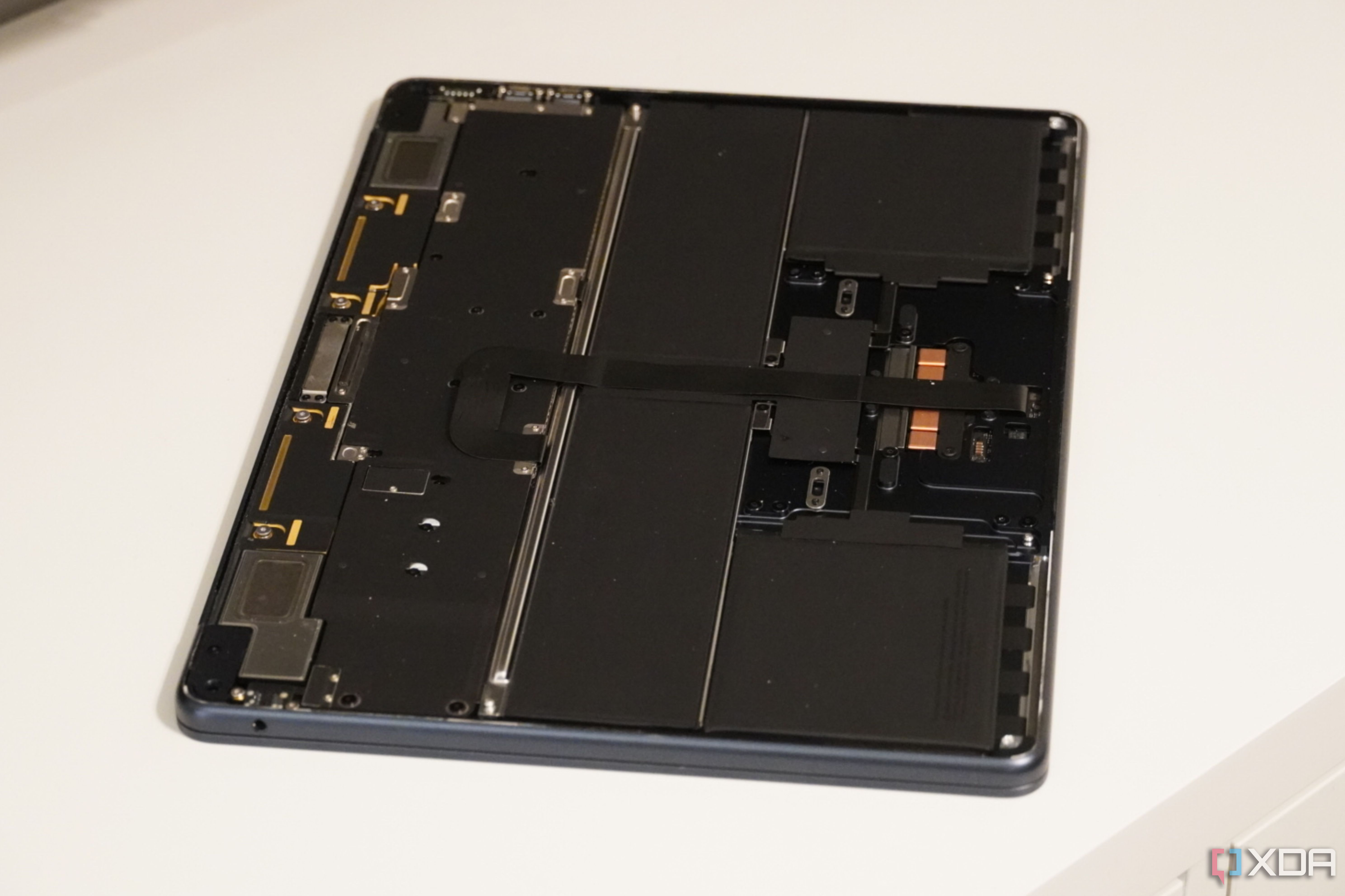 A wide shot of a MacBook with the bottom cover removed.
