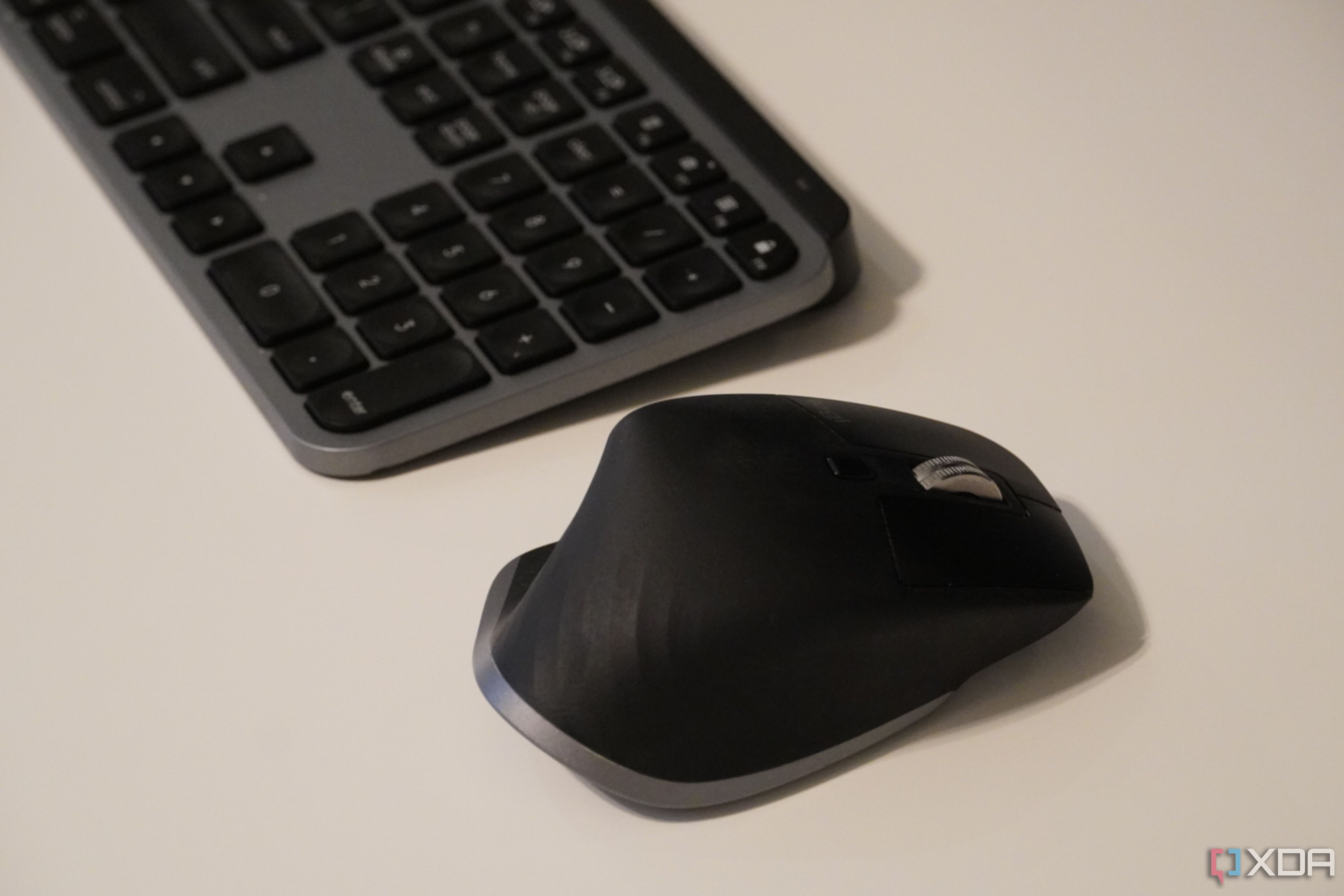 A side view of the MX Master 3 on a desk, with an MX Master Keyboard.