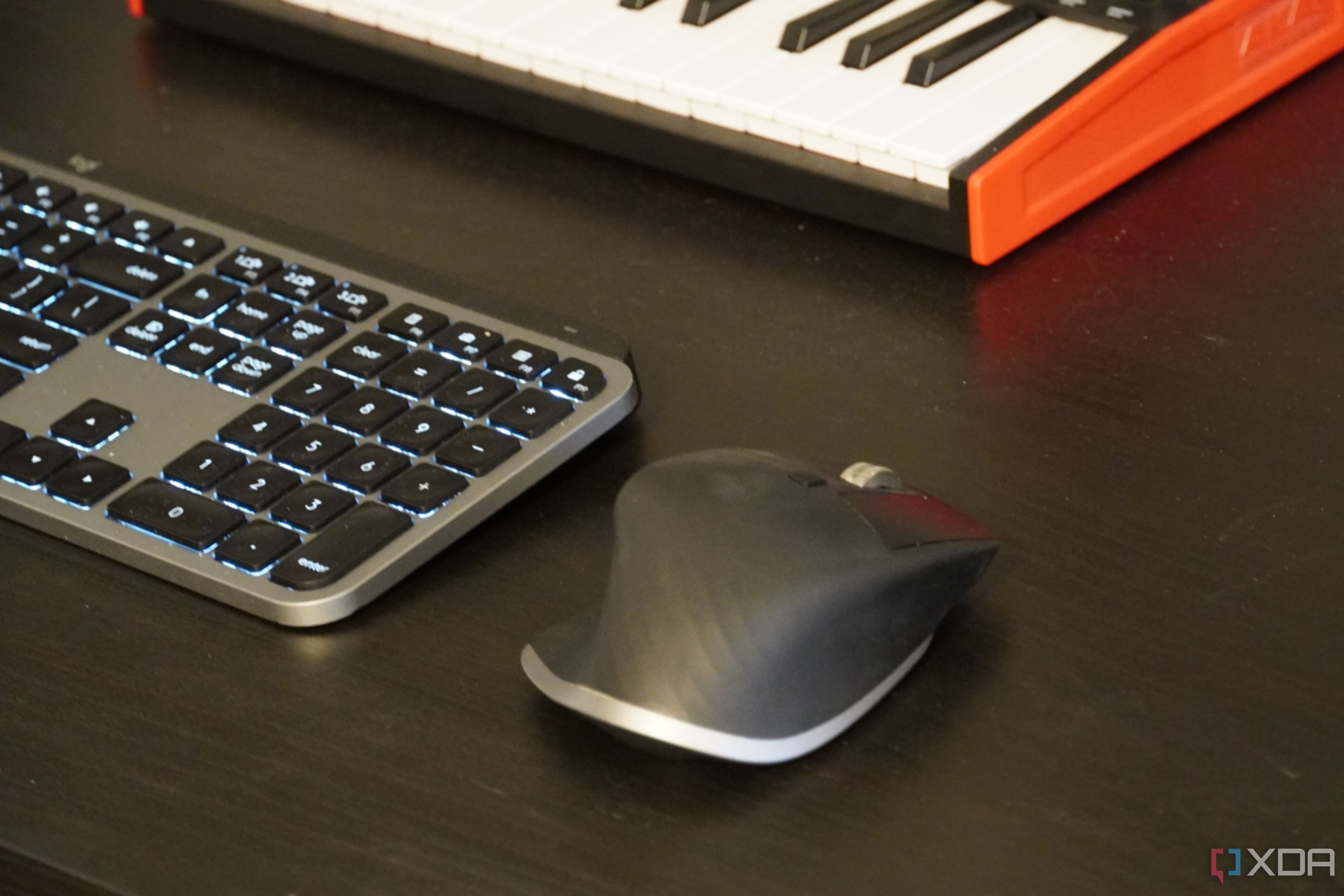An MX Master 3 mouse on a desk setup.