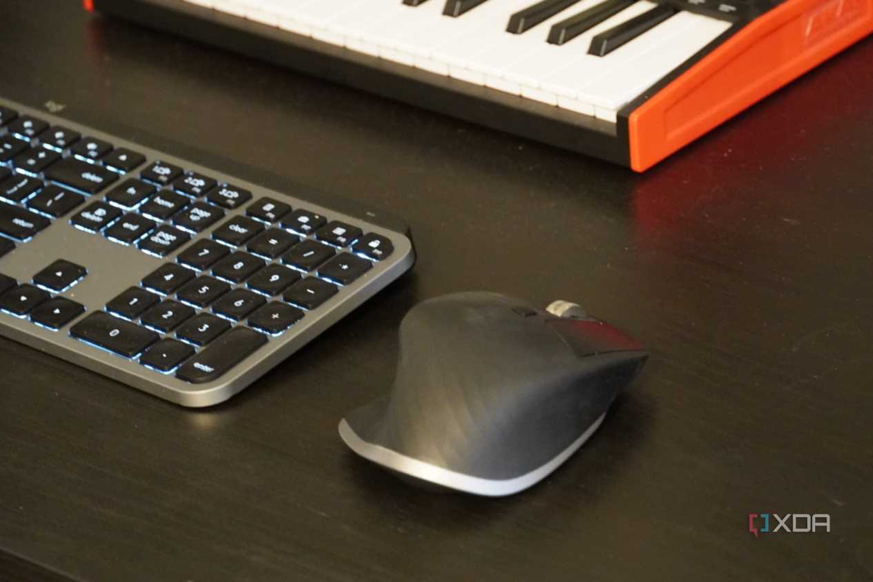 An MX Master 3 mouse on a desk setup.