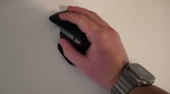 A hand resting on the MX Master 3 mouse.