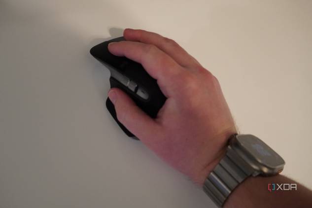 A hand resting on the MX Master 3 mouse.