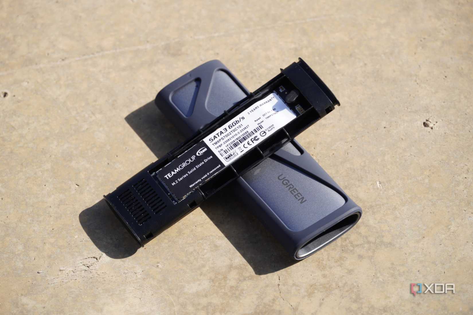 The UGreen SSD enclosure opened up on the ground
