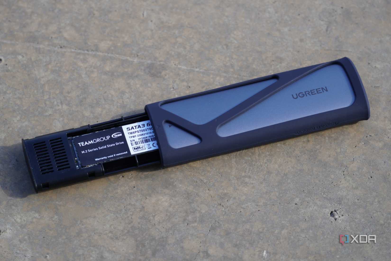 The Ugreen SSD enclosure half-opened.