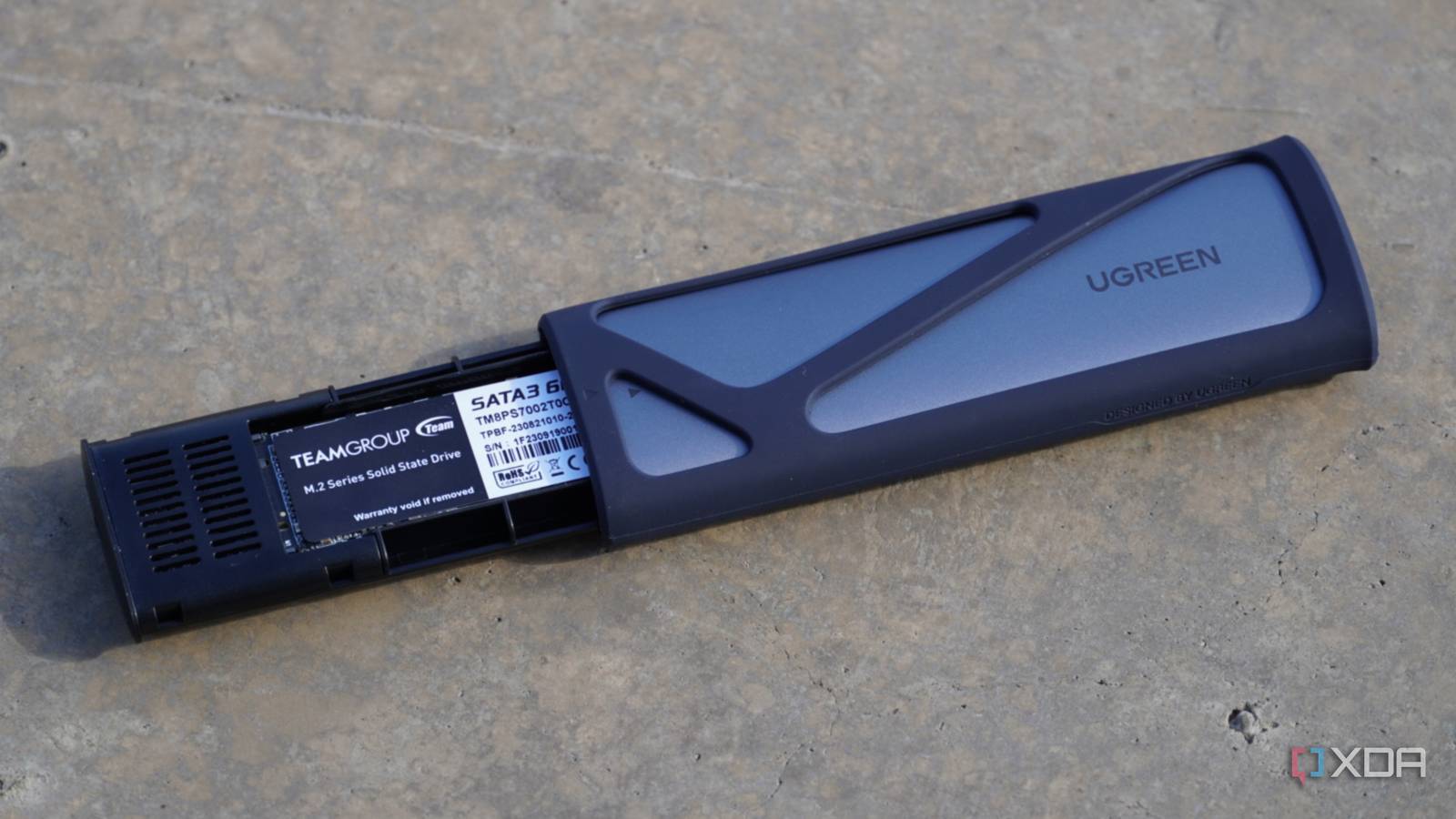The Ugreen SSD enclosure half-opened.