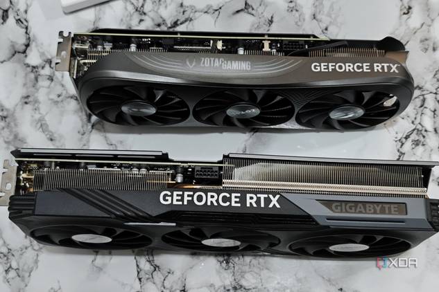 An image showing a Zotac Gaming RTX 4070 Super GPU kept next to Gigabyte RTX 4070 Ti Gaming OC GPU for size comparison.