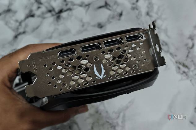 An image showing a person holding the Zotac Gaming GeForce RTX 4070 Super to show its ports at the rear.