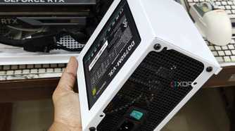 An image showing a person holding the PSU shroud with a PSU in hand.