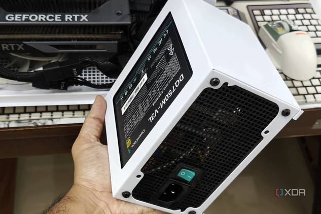 An image showing a person holding the PSU shroud with a PSU in hand.