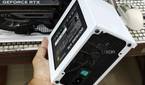 An image showing a person holding the PSU shroud with a PSU in hand.